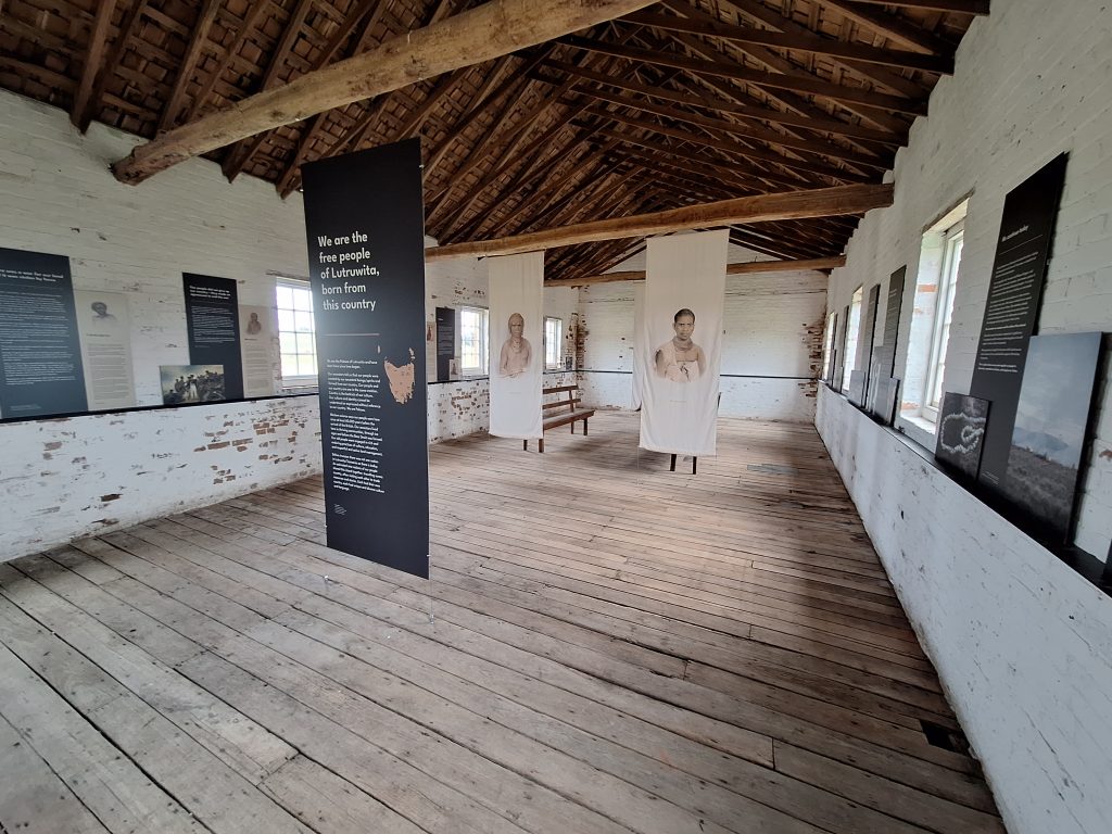 Inside of an old chapel with banners of names and images of Palawa Ancestors